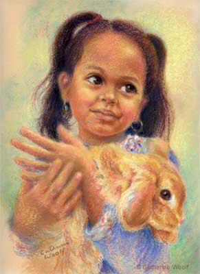 Little girl holding a rabbit.